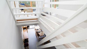 A spiral staircase leading to a dining area with a view of the outdoors. - 5 Seabird Close, Little Haven (Little Haven)