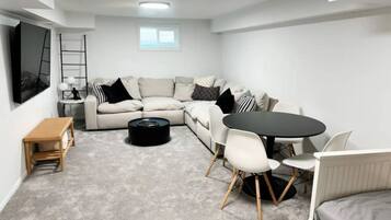 Signature House, Non Smoking, Hot Tub | Living room | 70-inch Smart TV with digital channels, books