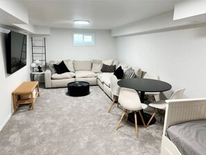 Signature House, Non Smoking, Hot Tub | Living room | 70-inch Smart TV with digital channels, books