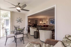 A spacious living area with a dining table, chairs, a sofa, and a ceiling fan. - 6052 WPW - Standard Plus - Spacious with a fabulous Bay View (Sarasota)