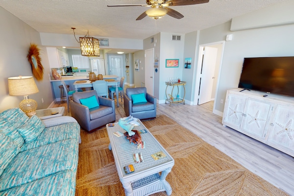 Open living, dining and kitchen. Smart TV in living room.