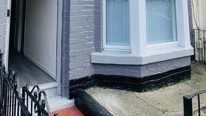 A residential building with a bay window and a door leading to a porch. - Remarkable 4-bed House in Bootle, Liverpool (Bootle)