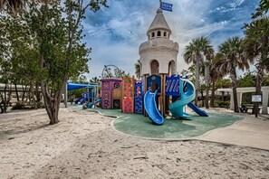 A playground with a castle-like structure, slides, and climbing areas.