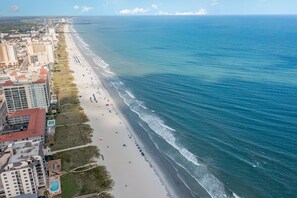 An aerial view of a beach with buildings on one side and the ocean on the other. - New Listing!  Ground Floor, Elegant 2 Bedroom Condo minutes from the beach. (North Myrtle Beach)