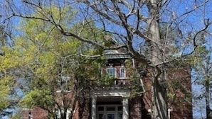A stone staircase leading to a brick building with a door and windows. - Historic home in the heart of Poplar Bluff (Poplar Bluff)