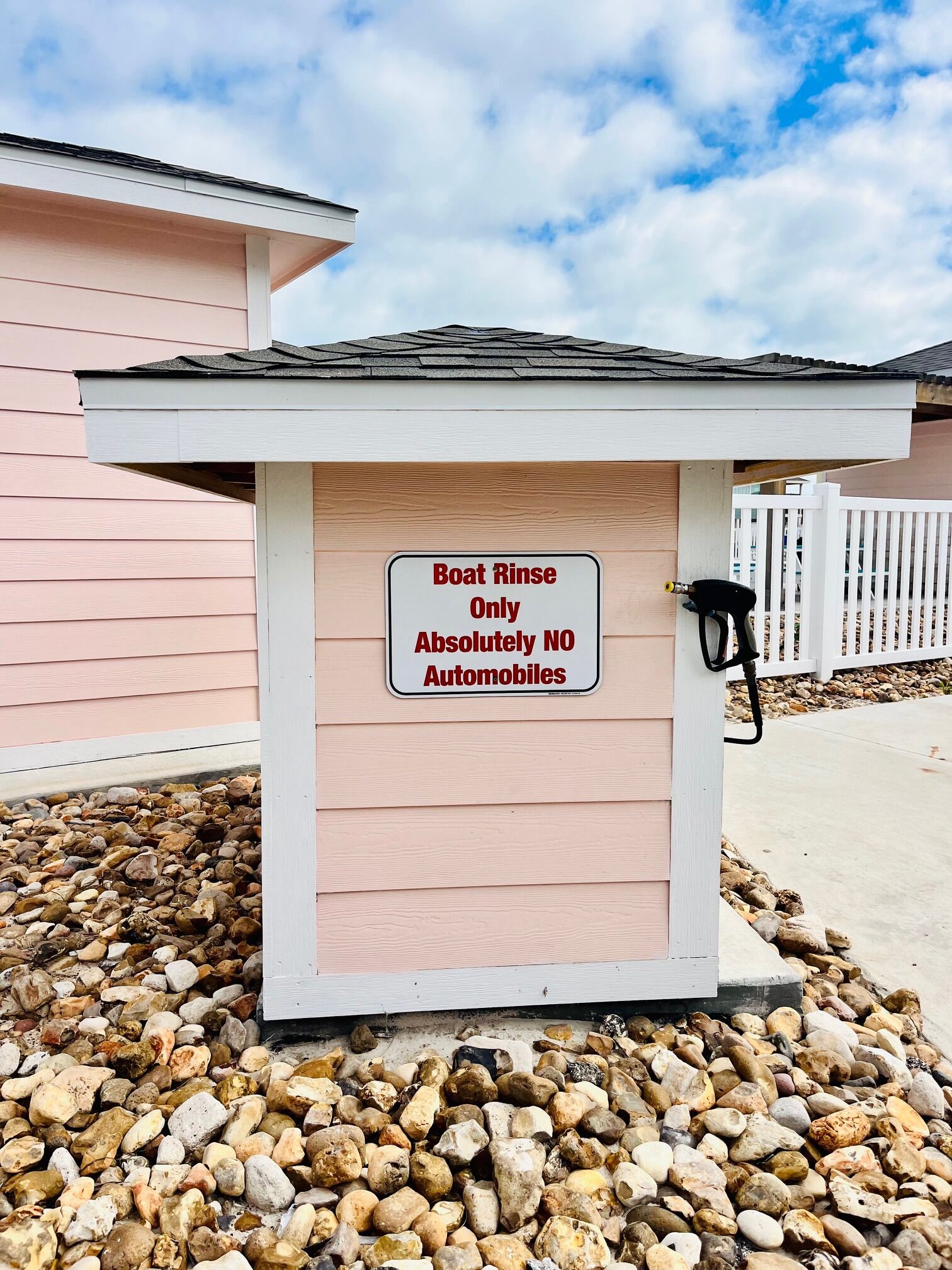 A boat rinse station with a sign stating "Boat Rinse Only Absolutely NO Automobiles."
