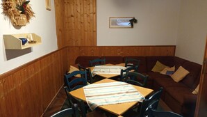 A cozy restaurant with wooden paneling, a brown couch, and striped tablecloths. - Nice apartment for 12 people with WIFI and pets allowed (Jilemnice)