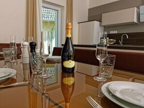 A dining table set with wine glasses, a bottle of Prosecco, and salt and pepper shakers. - Wonderful private villa for 10 people with WIFI, TV and terrace (Lojzova Paseka)