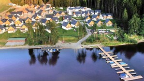 A residential area with houses and a dock extending into a body of water. - Beautiful private villa for 10 people with WIFI, TV and terrace (Lojzova Paseka)