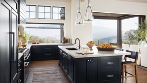 A modern kitchen with a large island, black cabinetry, and a view of the mountains. - Luxury Villa | Pool, Hot Tub & Views | Glen Ellen | 4BR | Sleeps 8 (Glen Ellen)