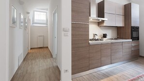 Een moderne keuken met houten kastjes, een fornuis en een inbouwoven.