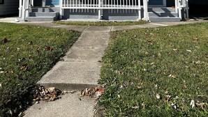 A two-story house with a front porch, a small front yard, and a clear blue sky. - Fenced in backyard. Great pet property.  Monon Trail access. (Indianapolis)