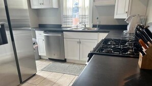 A modern kitchen with stainless steel appliances, a dishwasher, and a gas stove. - Fenced in backyard. Great pet property.  Monon Trail access. (Indianapolis)