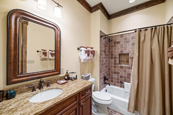 A bathroom with two sinks, a large mirror, a bathtub, and a shower area. - Heated Pool/Hot Tub/Theatre/Game/Fire/Sleep 34 (Gatlinburg)
