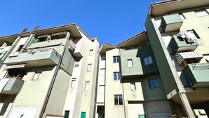 A multi-story residential building with balconies, windows, and a clear blue sky. -  P026 - Porto Recanati, three-room apartment with sea view 100m from the beach (Porto Recanati)