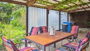 An outdoor patio with a wooden table and six chairs, each with a striped cushion. - 3 bedroom lovely home in Saal (Saal)