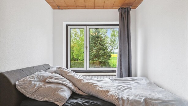 A bedroom with a bed, a window, and a view of a tree and field. - 3 bedroom lovely home in Saal (Saal)