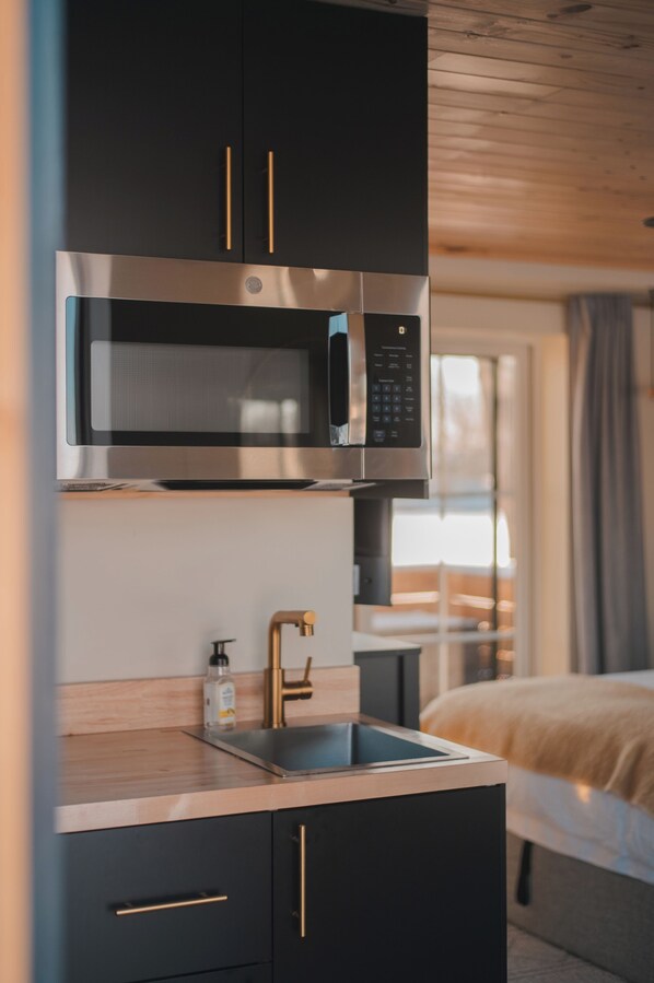 Fridge, microwave, coffee/tea maker, cookware/dishes/utensils