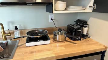Fridge, microwave, coffee/tea maker, cookware/dishes/utensils