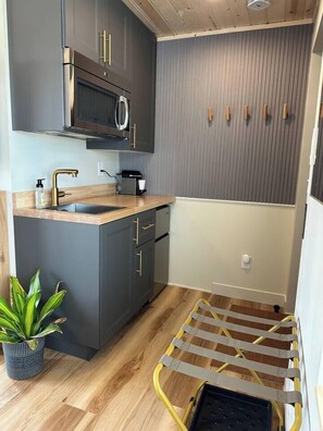 Fridge, microwave, coffee/tea maker, cookware/dishes/utensils