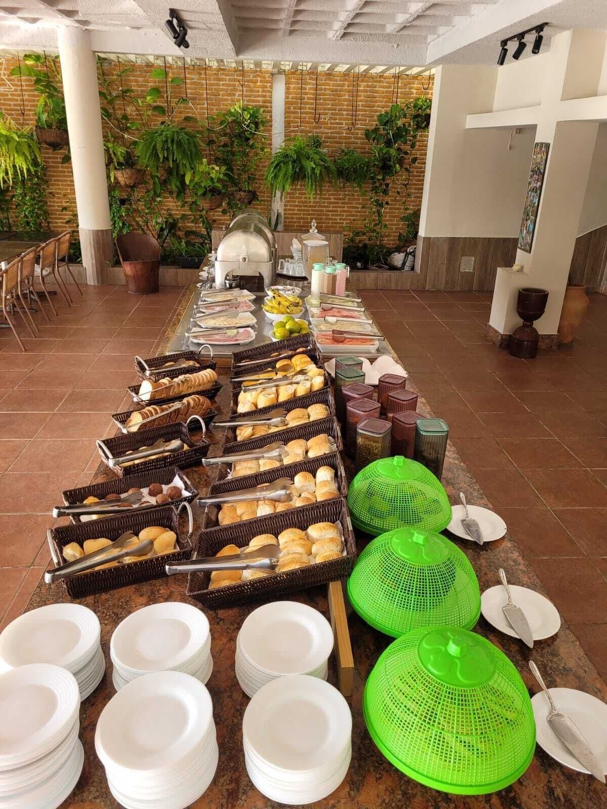 A buffet setup with various food items and serving utensils.