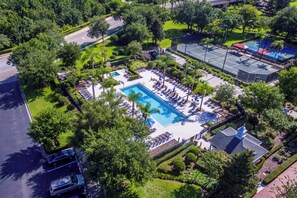 An aerial view of a resort with a central swimming pool, surrounded by sun loungers and palm trees. - 3 Bedroom 3 Bathroom Reunion 7658 (Four Corners)
