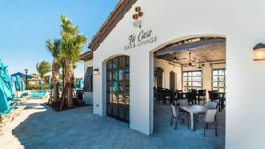 A bar and lounge named 'Ti Casa' with outdoor seating and a pool area in the background. - 5 Bedroom 4 Bathroom Windsor at Westside 8933PW (Kissimmee)