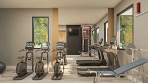 A modern gym with stationary bikes, treadmills, and a bench.