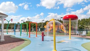 A water park with various play structures and a covered area. - 4 Bedroom 3 Bathroom Villas At Seven Dwarfs 10-102 (Kissimmee)