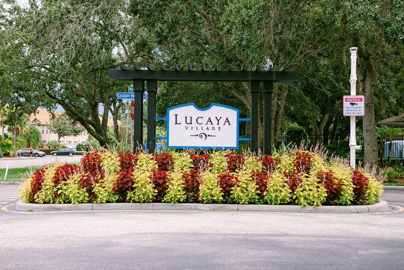 A sign for Lucaya Village with a security notice.