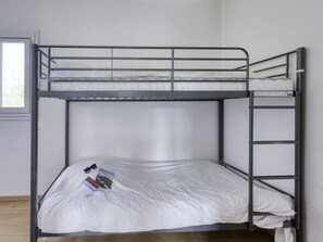 Sleep comfortably in this cozy room with a bunk bed featuring two levels of sleeping space and a convenient ladder for easy access.