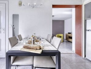 Enjoy meals with family and friends in this dining area, which offers a spacious table for four and comfortable seating.