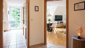 A modern interior with a dining area, a TV, and a plant. - Cozy heath idyll in the countryside (Schneverdingen)