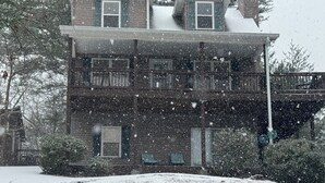 A two-story building with a balcony and a chimney. -  Spacious mountain home in Helen Georgia! Innsbruck community HOT TUB! FIRE PIT! (Helen)