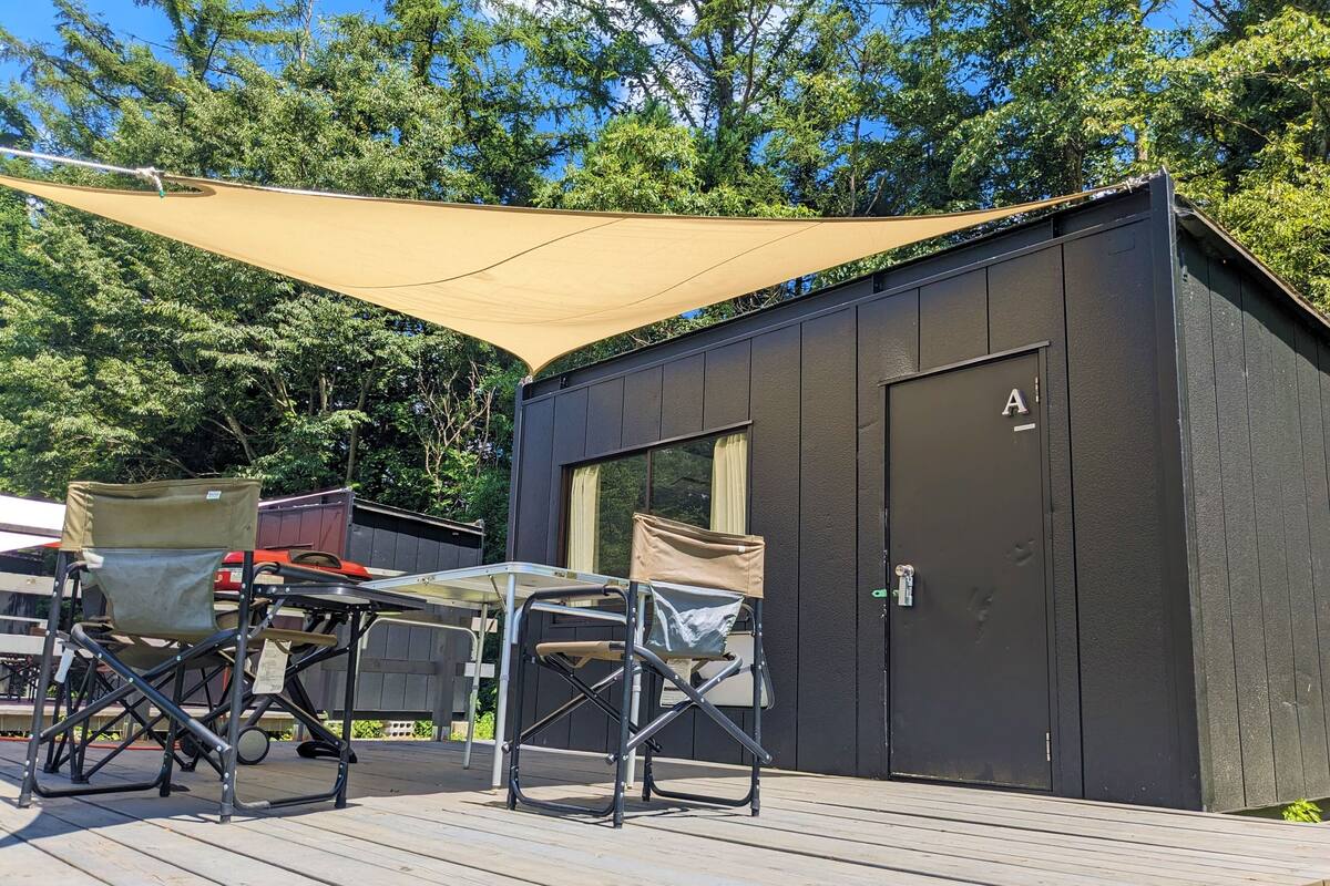 A deck with outdoor furniture and a shaded area.