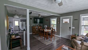 A spacious living room with a dining area, a kitchen, and a separate dining room. - Trail Riders Retreat! Hatfield McCoy Trails. Private Pool. Loads of Parking!  (Williamson)