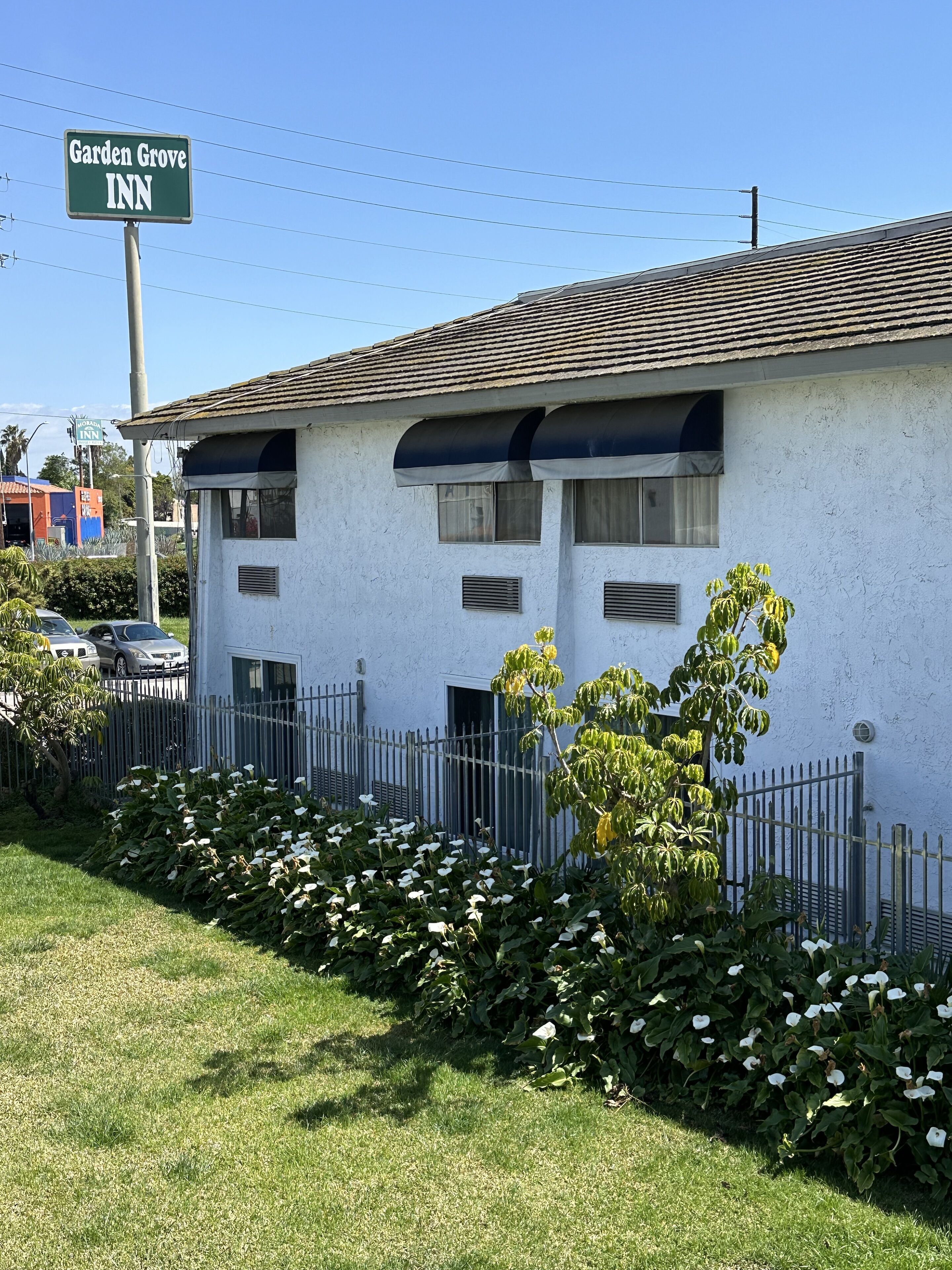 A two-story building with a sign reading "Garden Grove INN".
