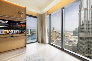 A spacious room with a large window offering a view of a cityscape and a high-rise building. - NEW | 3BR Burj Fountain NYE View | Address (Dubai)