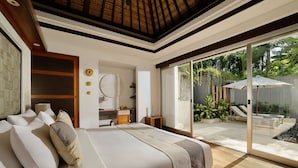 A bedroom with a large bed, a wooden ceiling, and a sliding glass door leading to a patio with outdoor furniture. - Jimbaran Bay Villas by Nakula (Kedonganan)