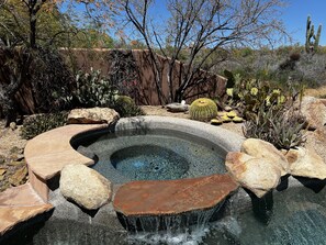 A hot tub surrounded by rocks and cacti in a desert garden. - Desert living with gourmet kitchen, pool, spa, and separate casita! (Scottsdale)
