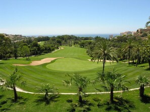 Ein Golfplatz mit freiem Blick auf das Meer und die umliegende Natur.