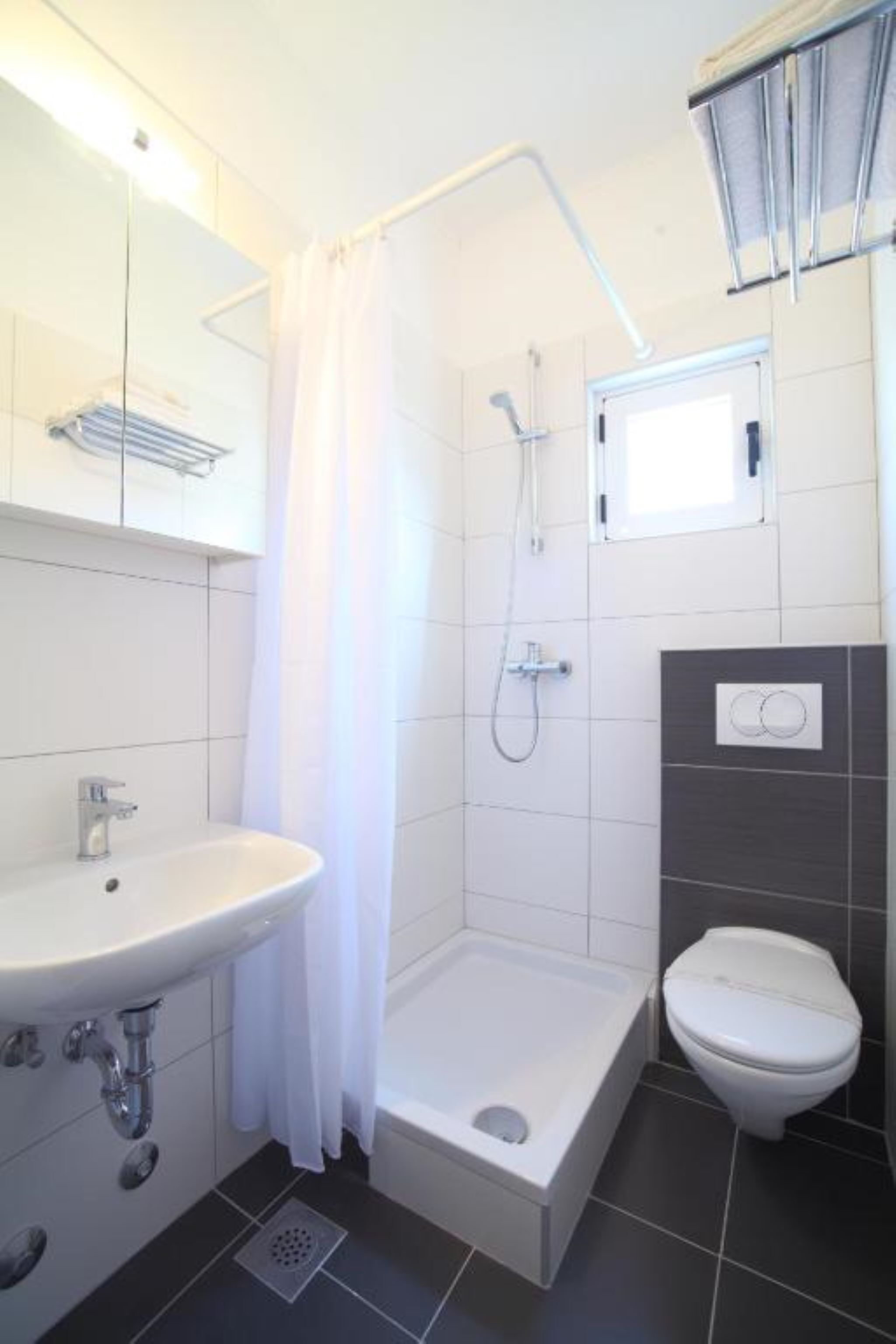 Un baño moderno con ducha, inodoro y lavamanos.