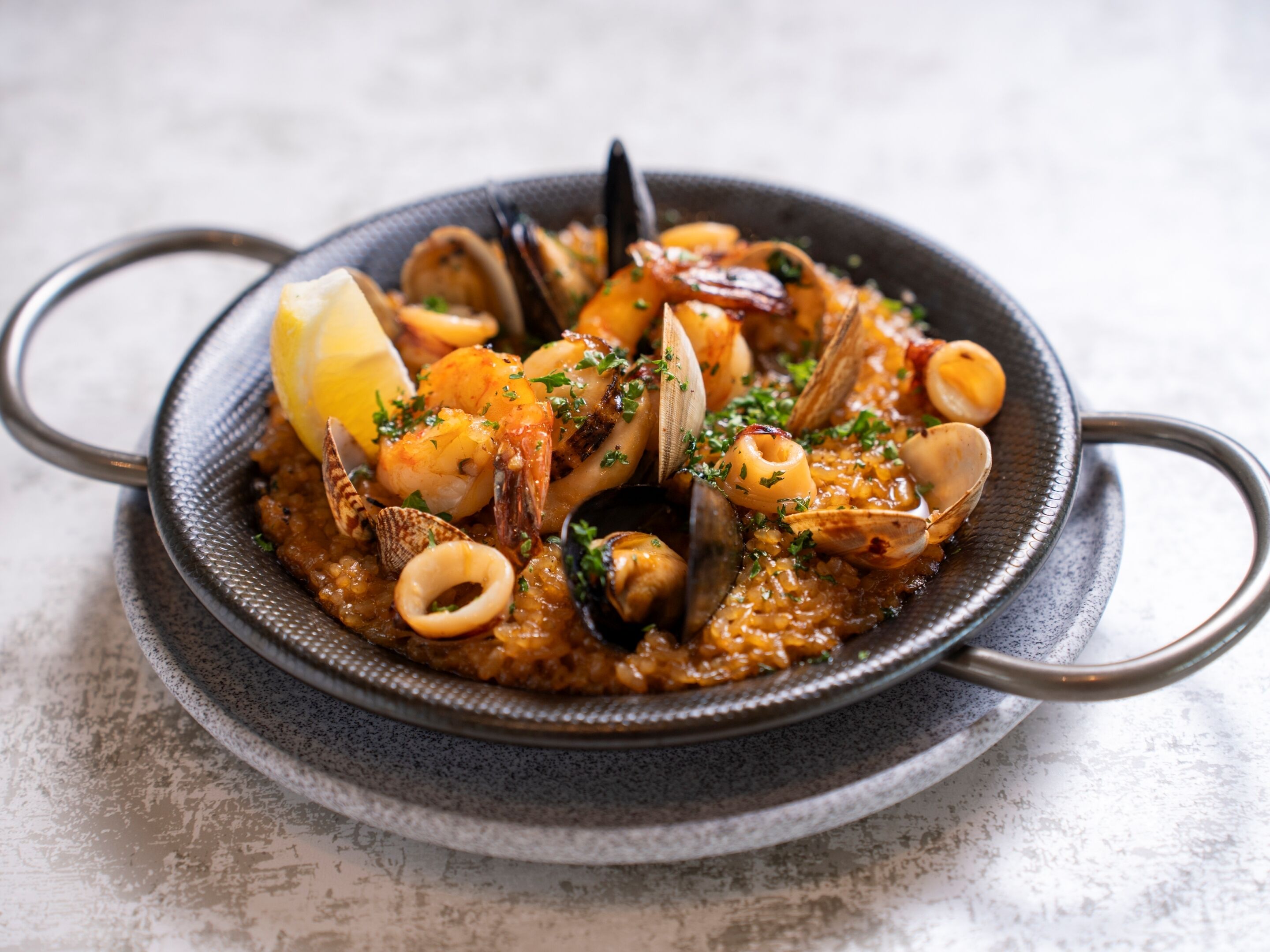A seafood dish in a bowl with a textured exterior.