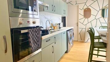 Design Townhome | Private kitchen | Espresso maker, electric kettle, dining tables