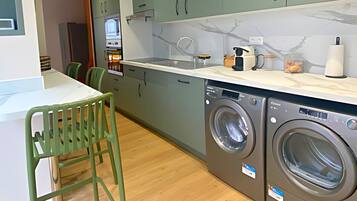 Design Townhome | Private kitchen | Espresso maker, electric kettle, dining tables