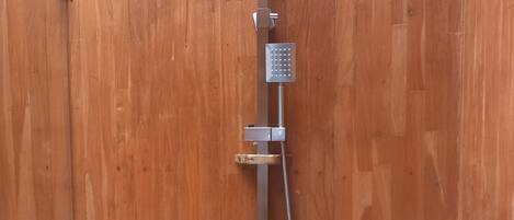 A wooden door with a built-in shower system.