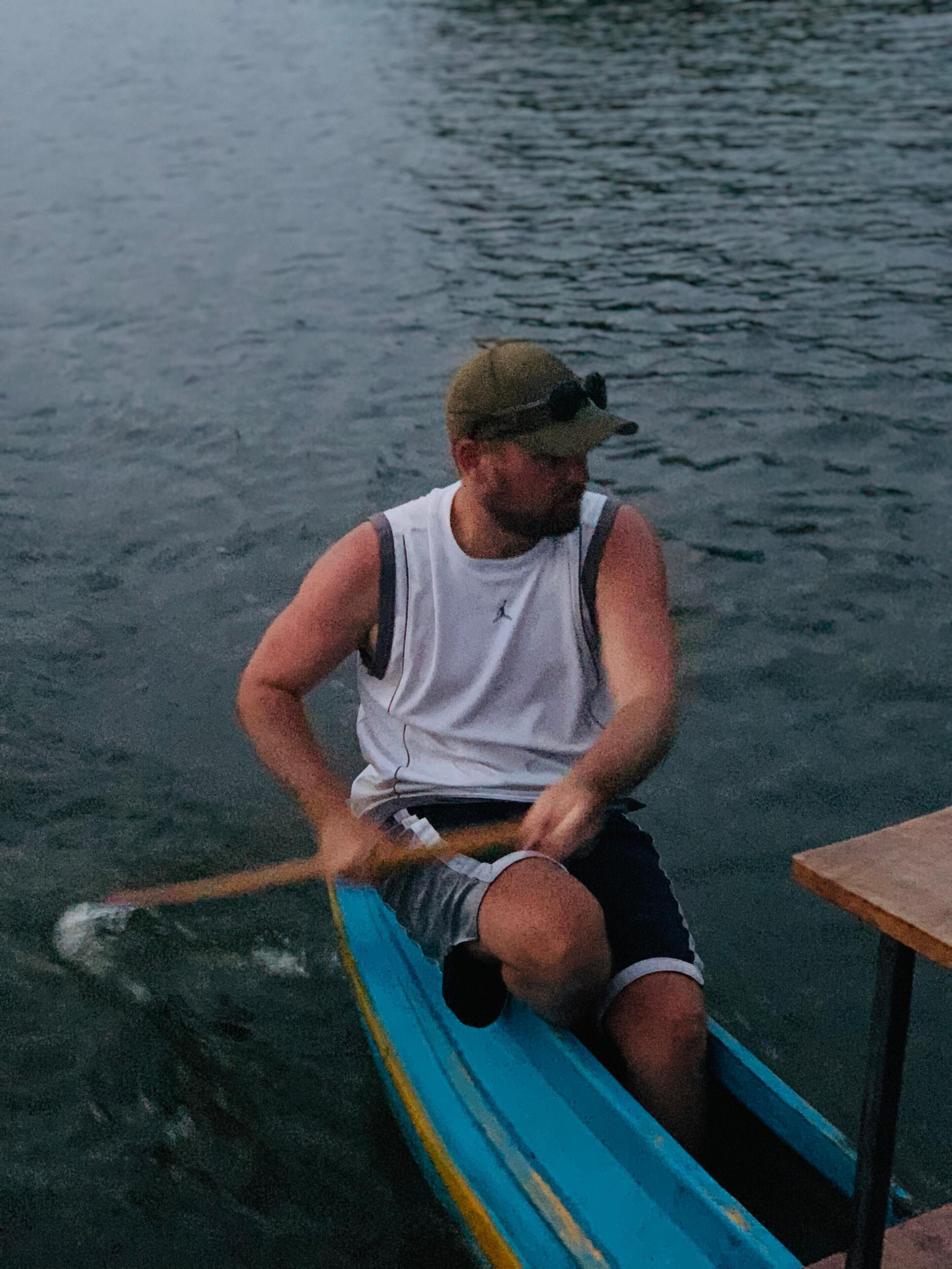 A person rowing a canoe on a body of water.