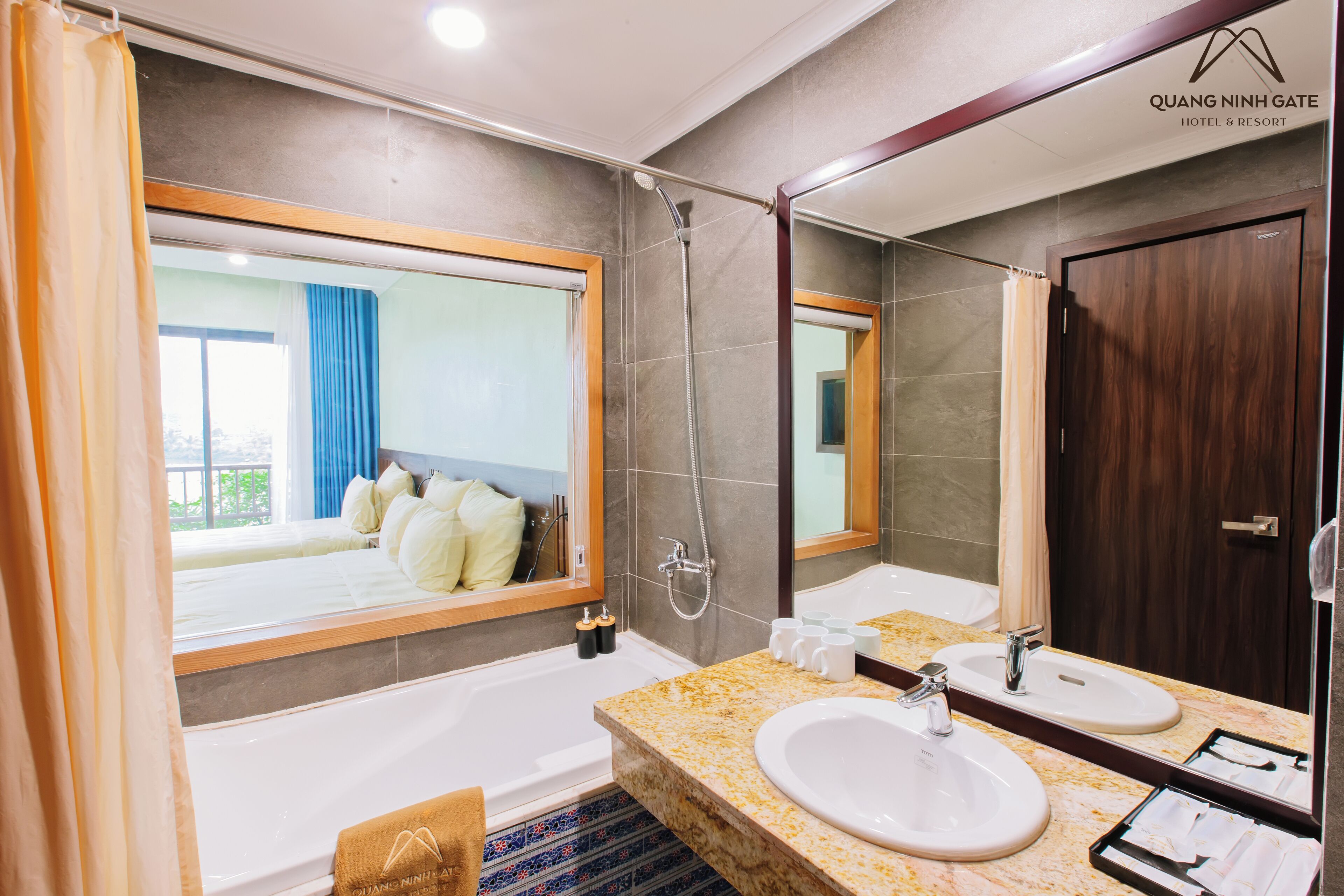 A modern bathroom with a large mirror, two sinks, a bathtub, and a shower.