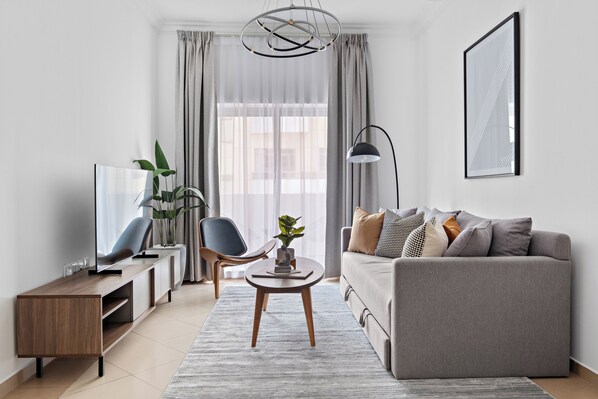 Apartamento empresarial, 1 quarto, vista para a cidade | Área de estar | TV LED 50 polegadas com canais a cabo