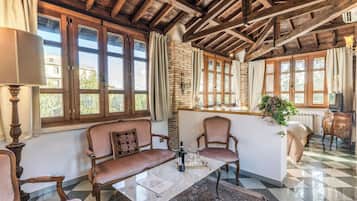 Deluxe Studio Suite, 2 Bedrooms, Garden View | Living area | 32-inch Smart TV with digital channels